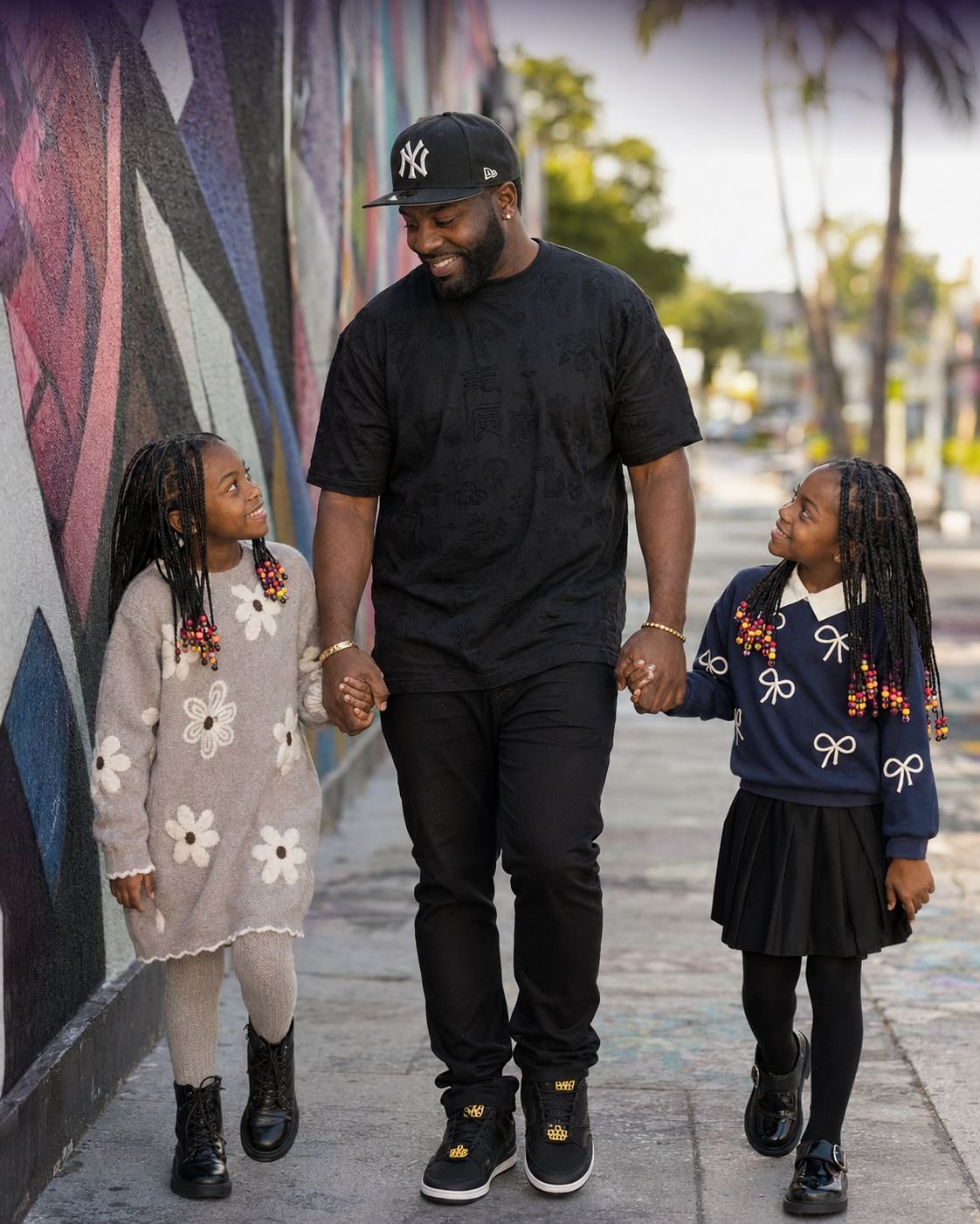 Micah Berkley with his twin daughters Michaela and McKenzie Berkley